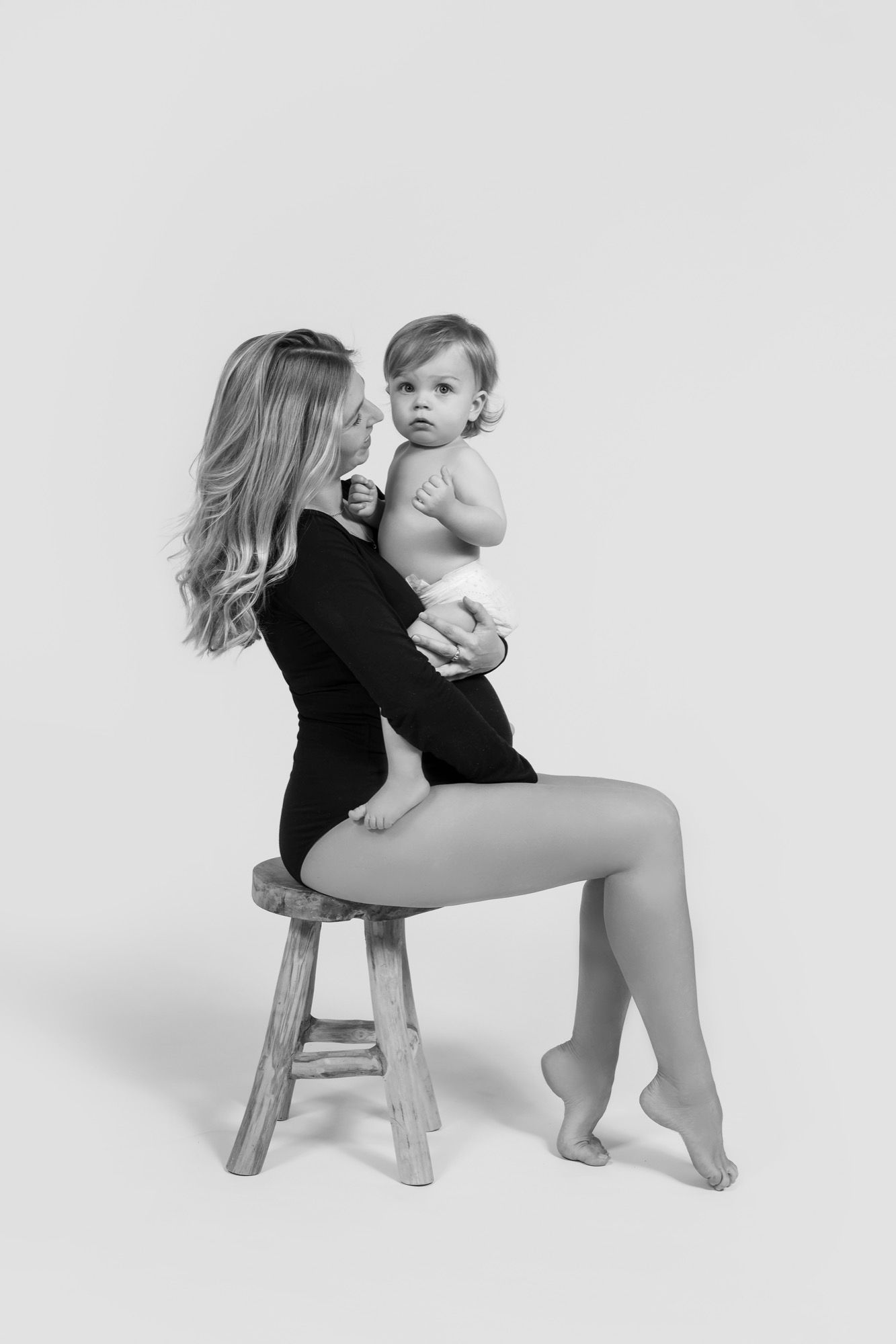 Mother carrying her baby of a few months, portrait in black and white (3)